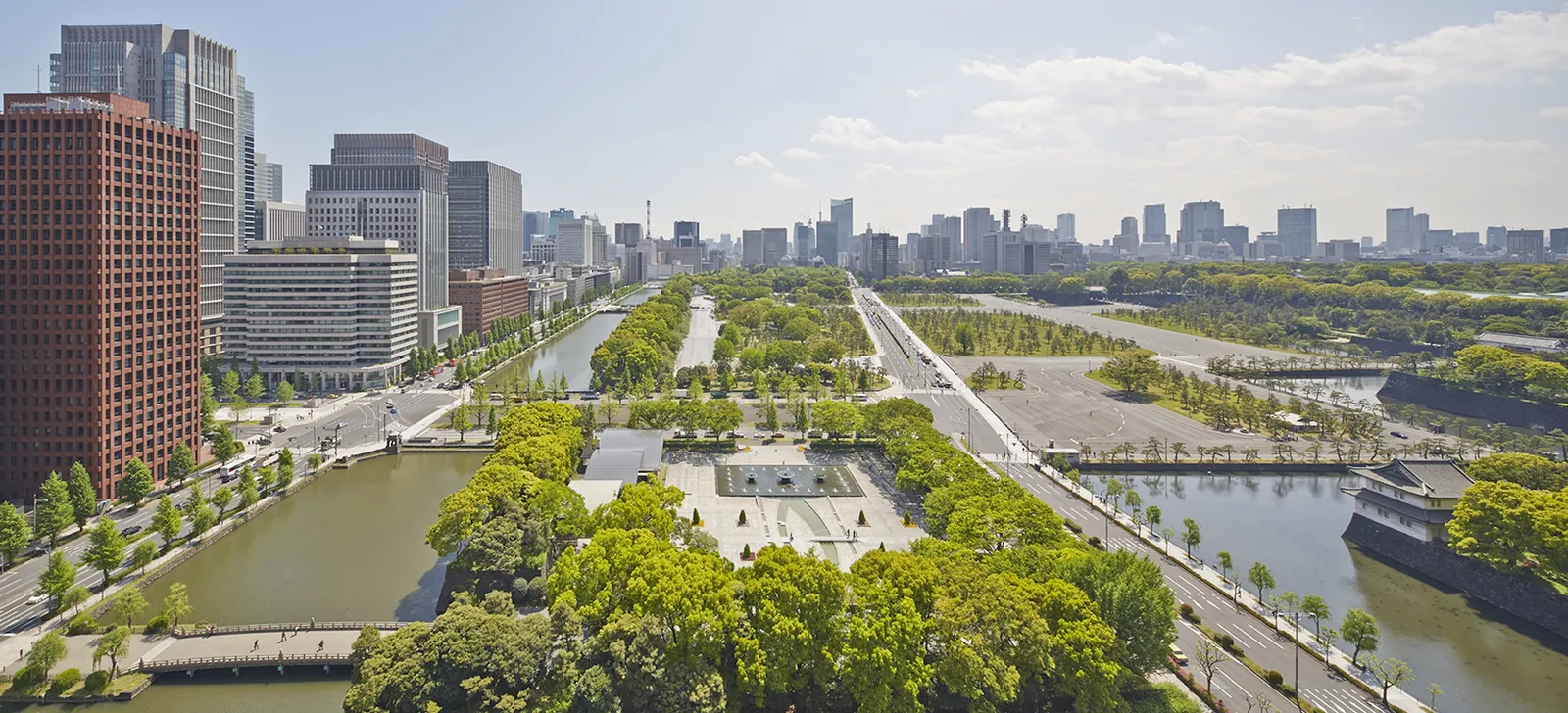 Wadakura Fountain Park and the moat from above, with the Imperial Palace plaza and the Tokyo skyline on the horizon.