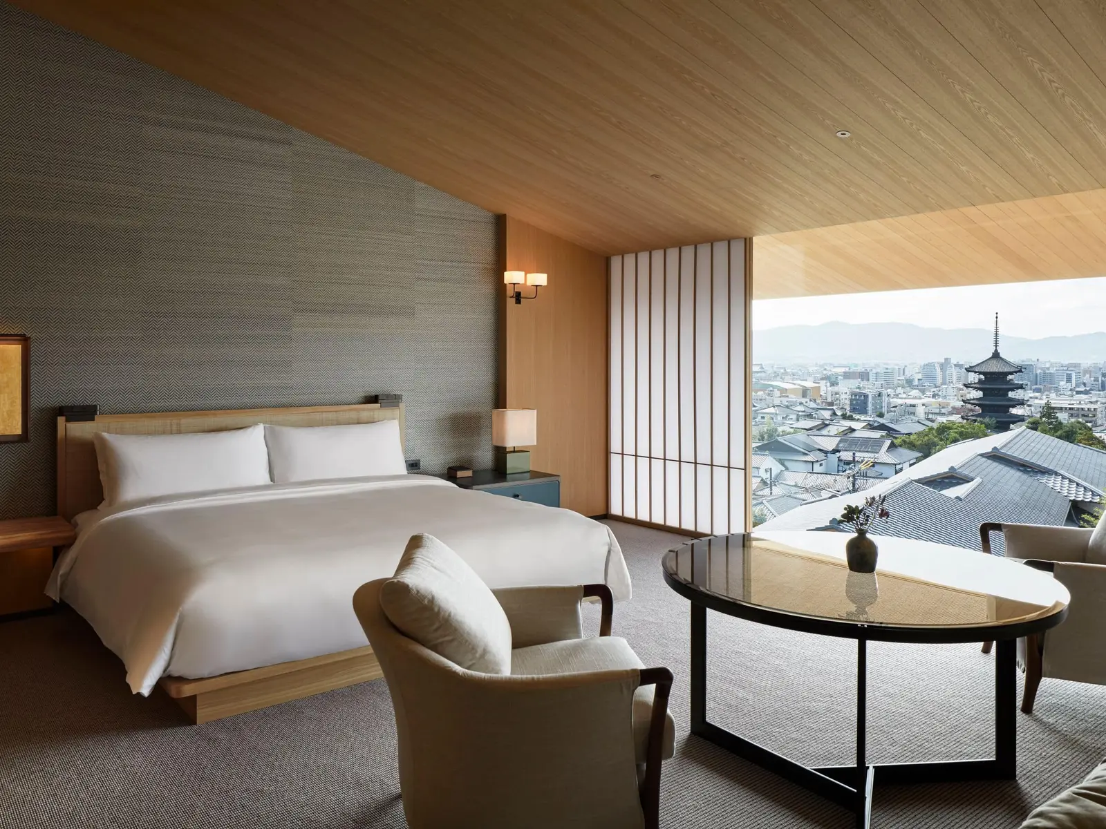 The deluxe pagoda-view king room, with its round table and the city running to the mountains.