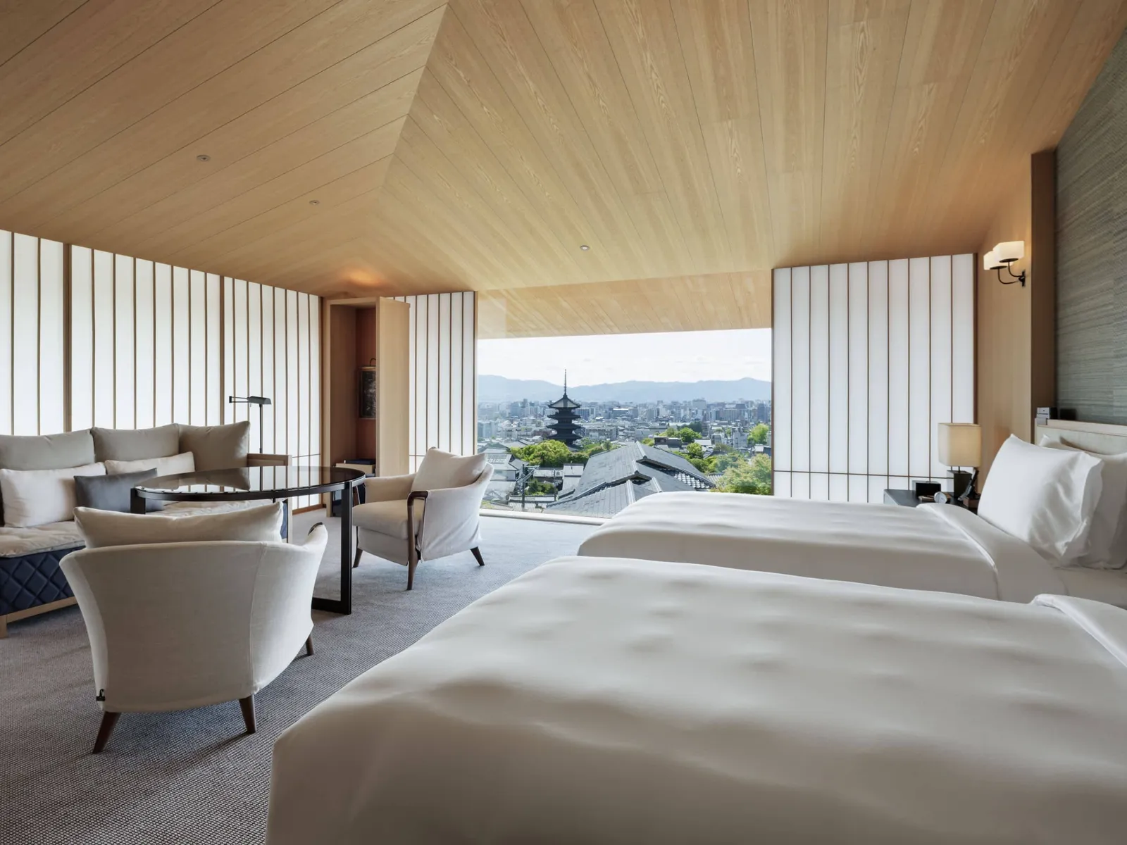 The deluxe pagoda-view twin room, wide and light, with the sitting area under the glass.