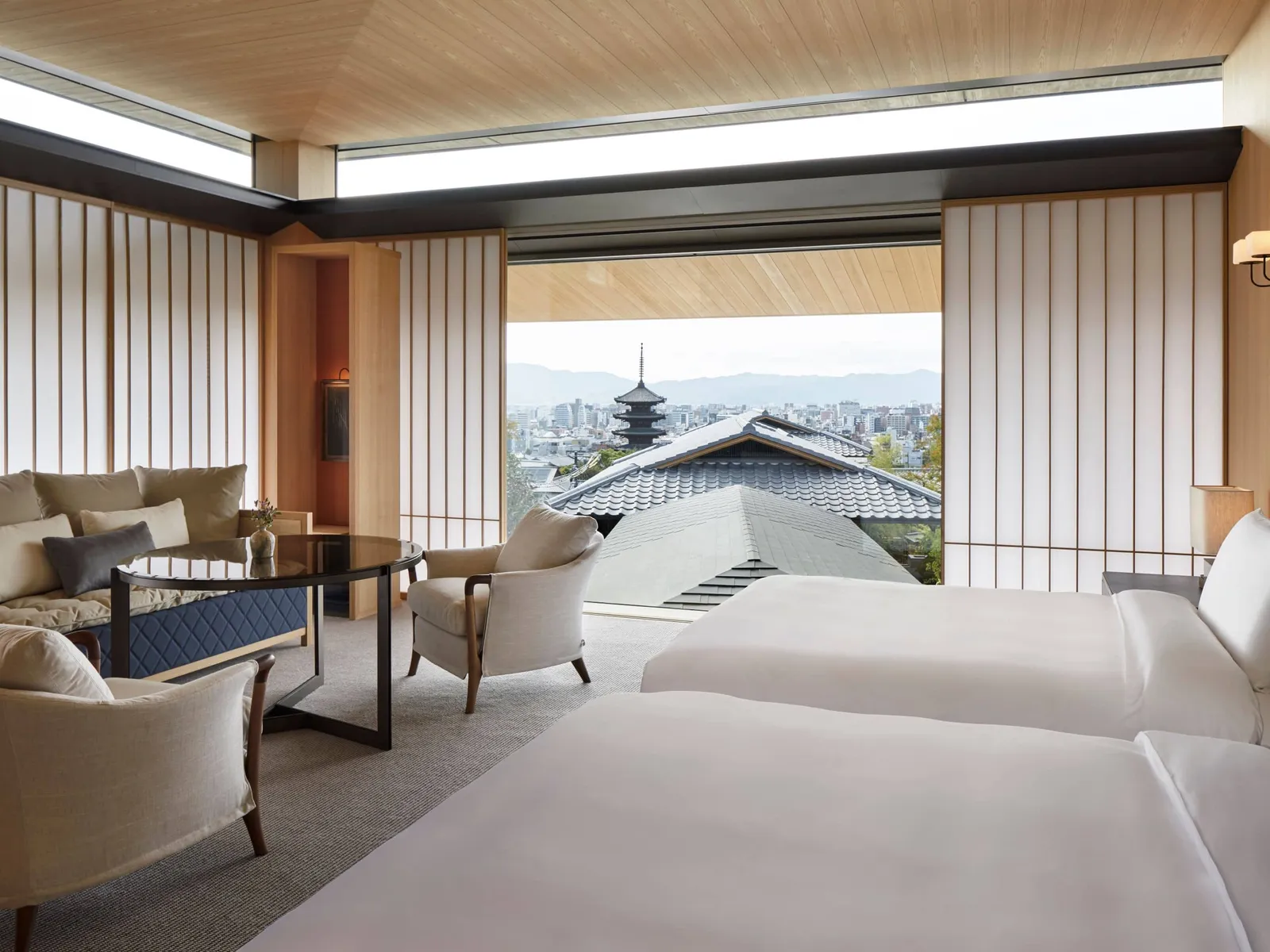 The deluxe twin room, its paper screens open onto the pagoda and the roofs of Higashiyama.