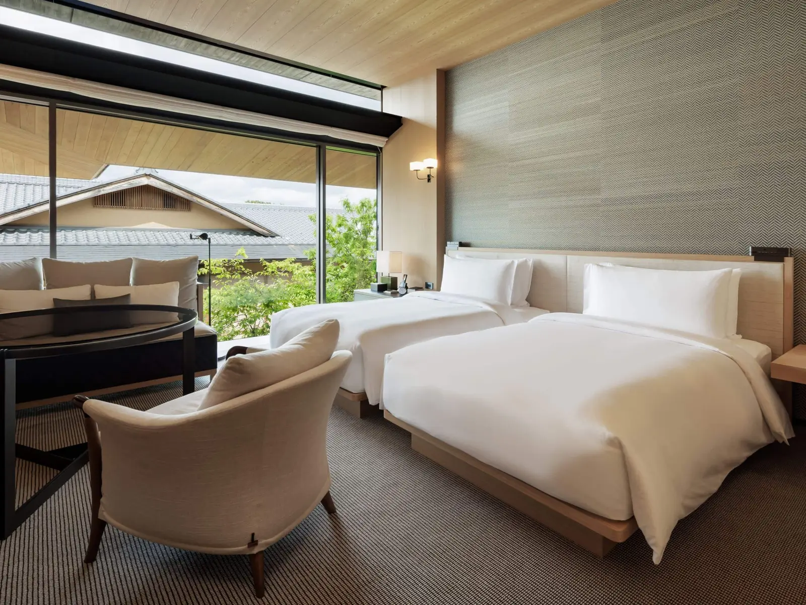 The garden-view twin room, with tiled roofs and greenery beyond the glass.