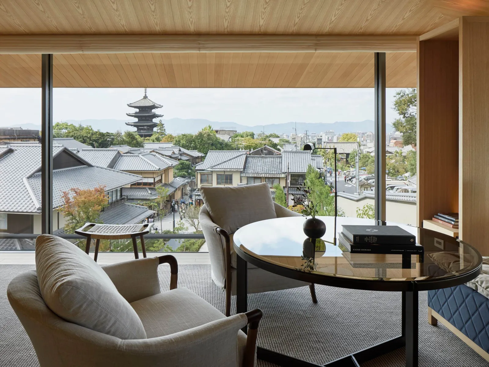 The Ninenzaka House living room, open onto the roofs of Ninenzaka with the pagoda beyond.