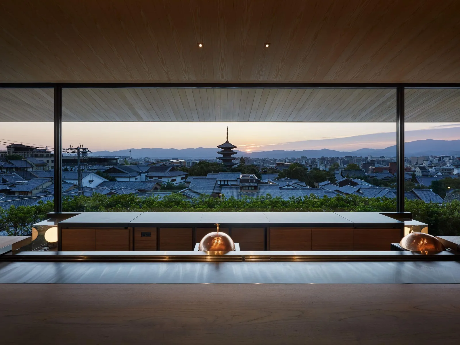 Yasaka’s teppanyaki counter in front of the glass wall: the pagoda and the city at sunset.