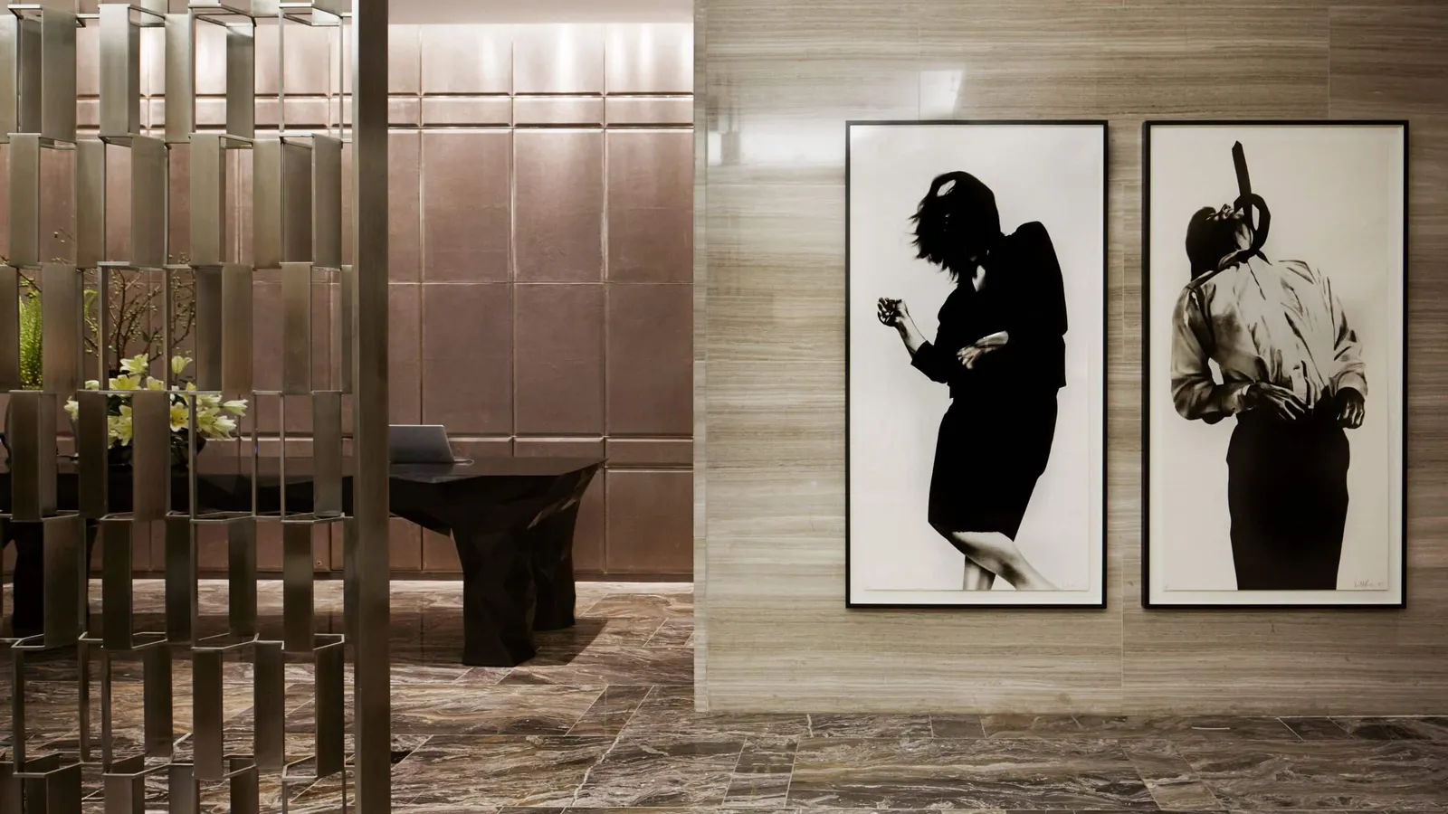 Black-and-white photographic works beside the reception desk