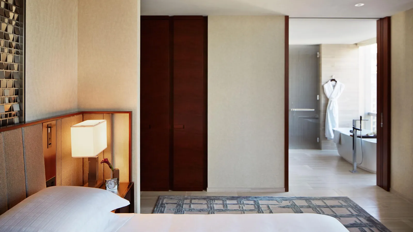 King bed and open doorway towards the bathroom and bathtub