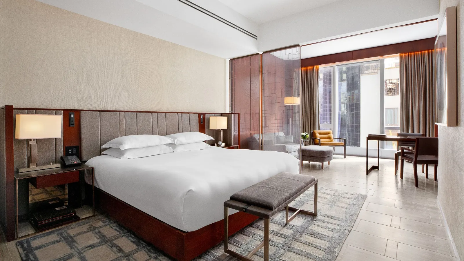King bed, bench and sitting area beside the windows