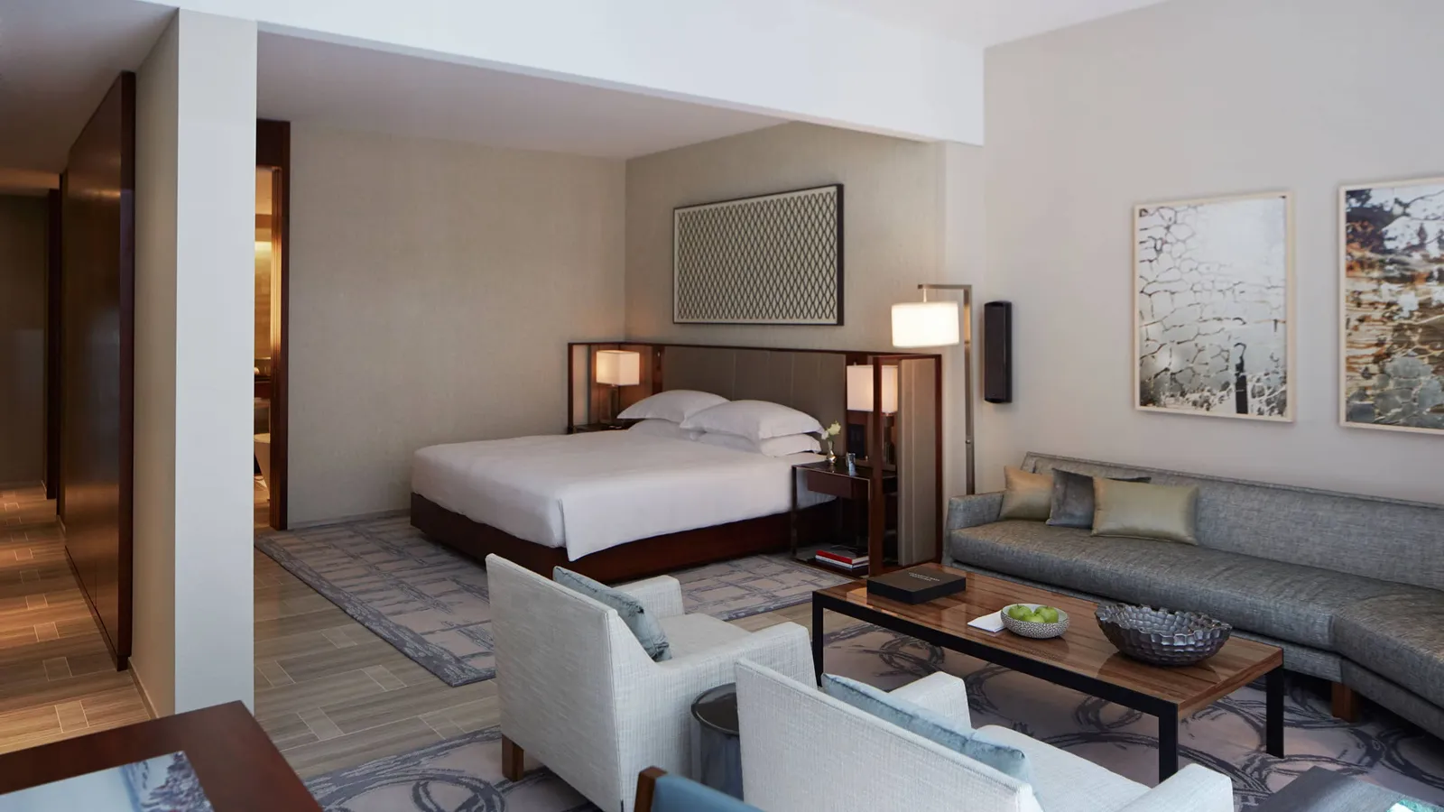 King bed, sofa and armchairs within the suite