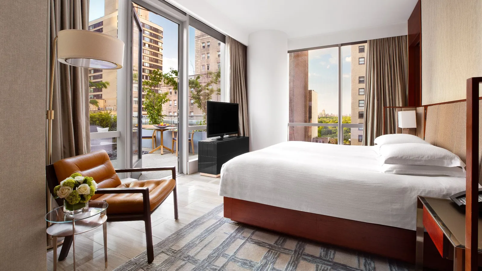 King bed and glass doors opening towards the terrace