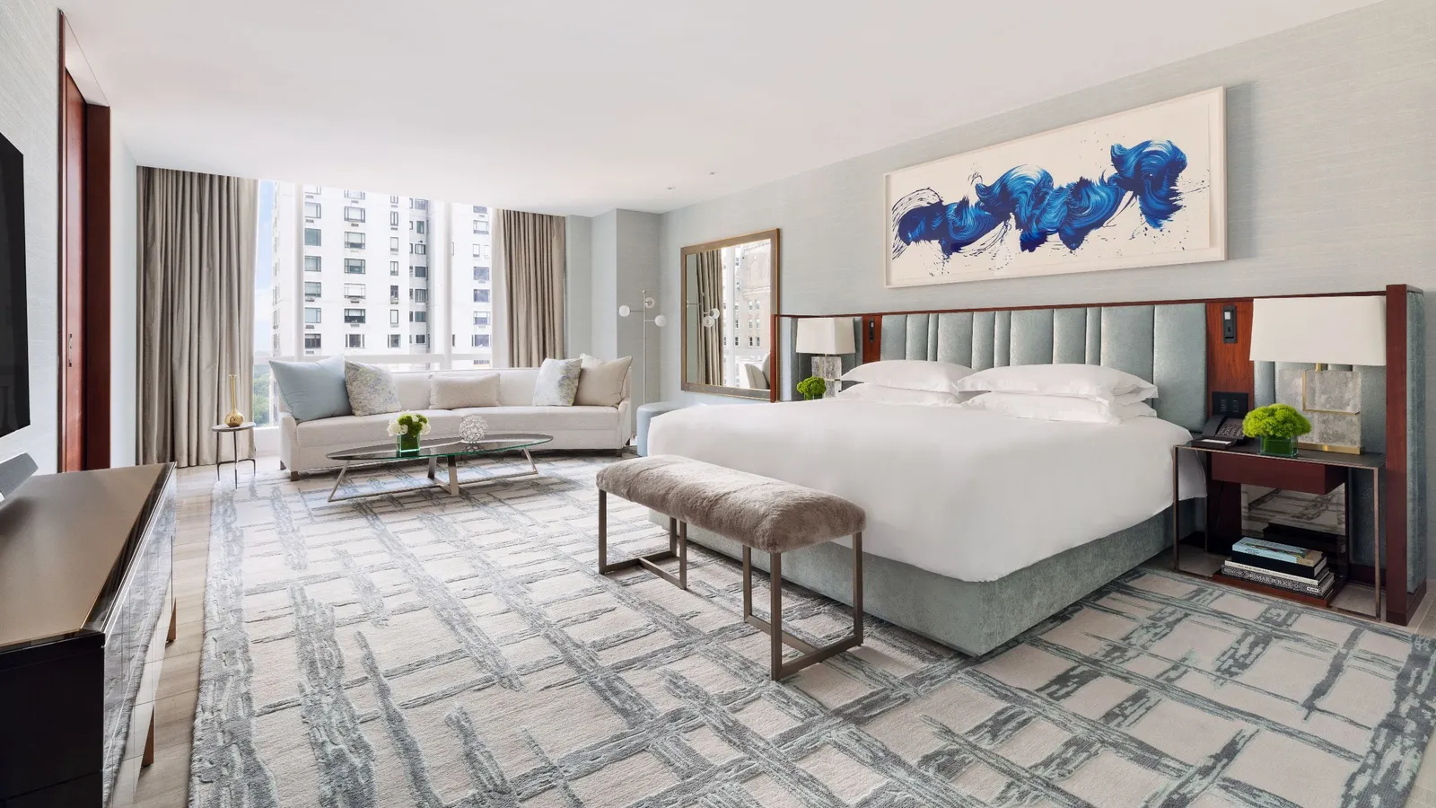 Bed and sofa in the photo supplied by the hotel for the Presidential Suite