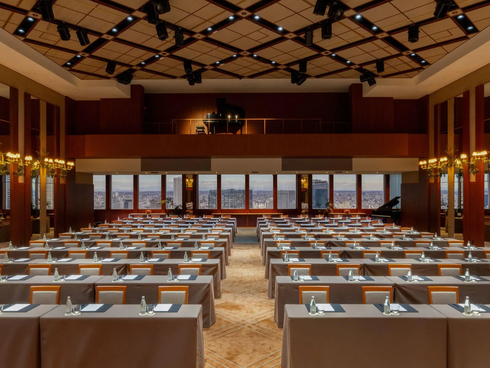 The Ballroom set for a conference: rows of tables, the coffered ceiling, the musicians’ balcony and the windows onto the city.