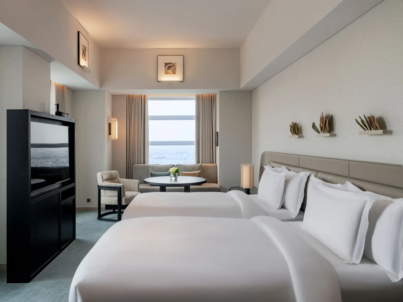 The Premier with 2 double beds on the 51st floor: the beds, the small table under the window and the television.
