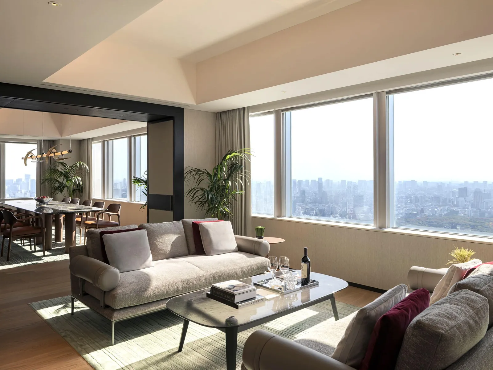 The Presidential Suite living room on the 51st floor: the sofa, the dining table and the windows onto the city to the horizon.