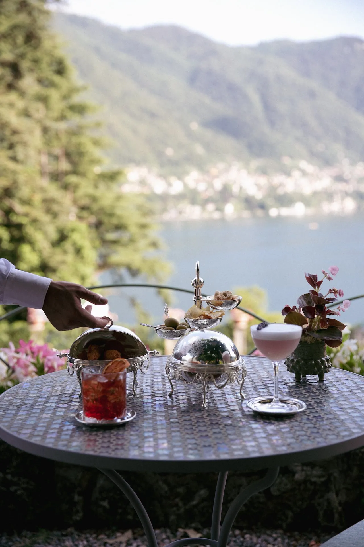 Aperitivo served at a garden table above the lake