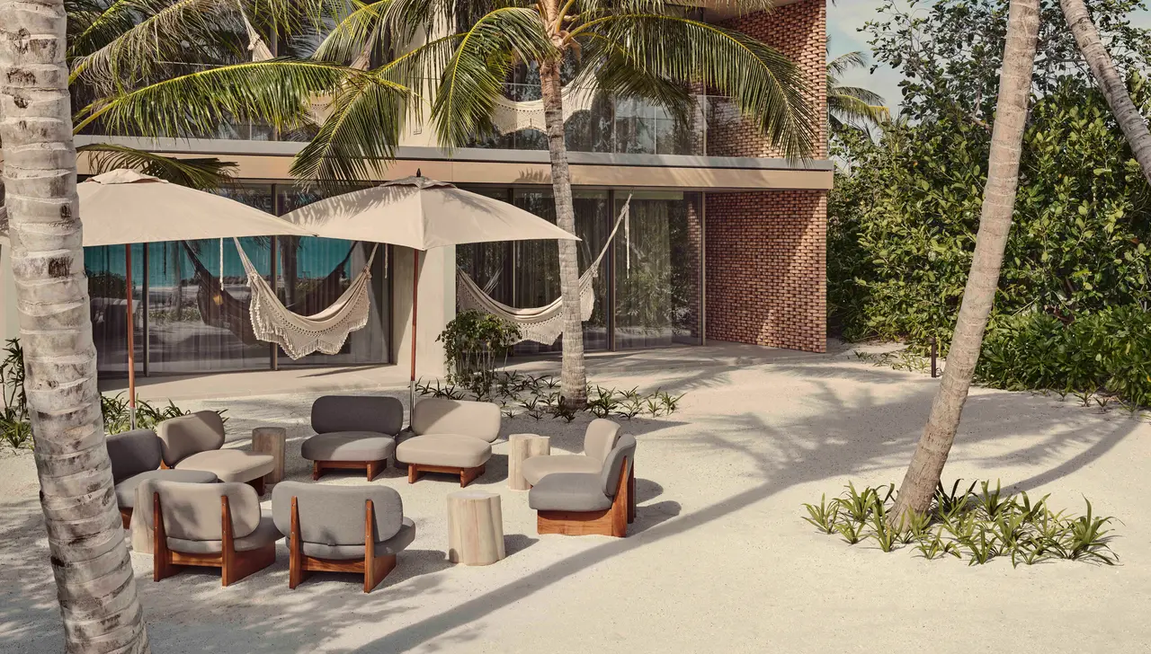 The Fari Studios building: 2 storeys of brick, hammocks and sofas under parasols on the sand