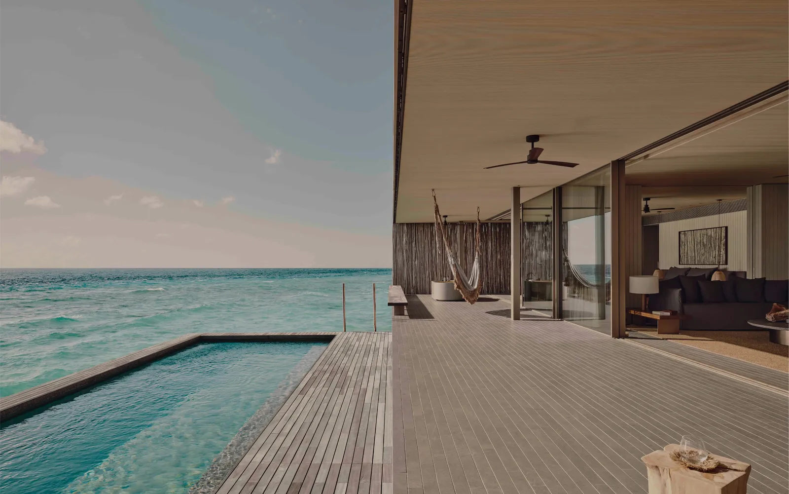 The long pool on a water villa’s deck, level with the turquoise sea