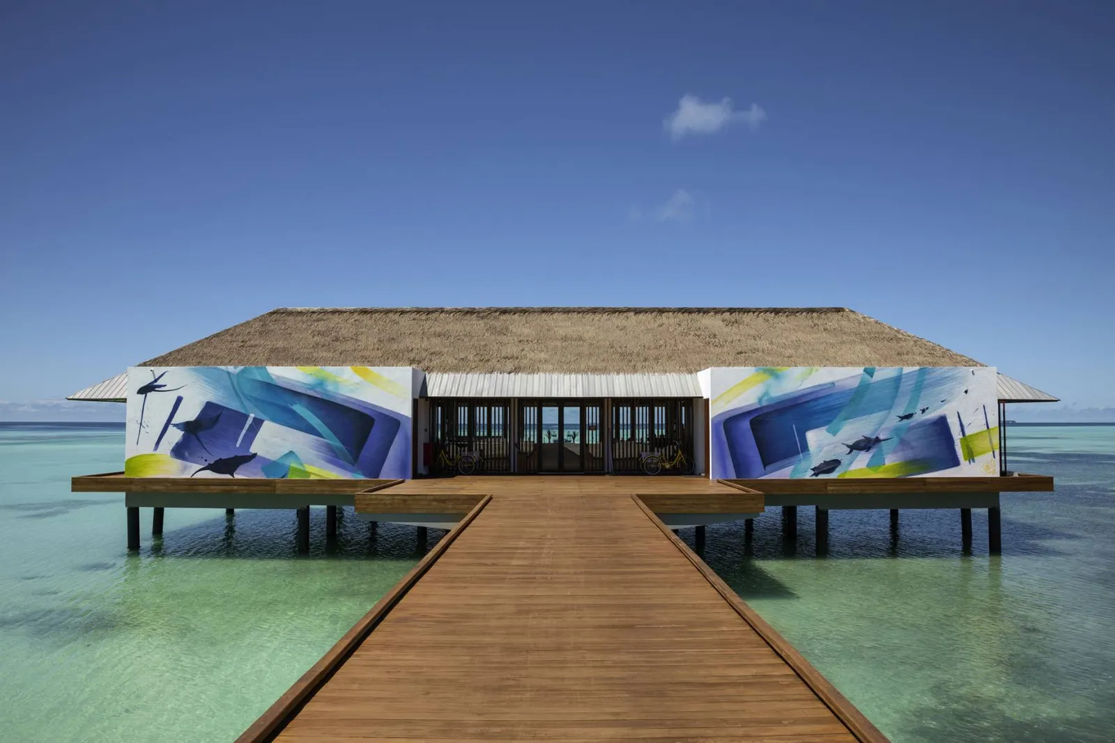 The timber jetty to Saffron Affair, the overwater bar with its blue-painted walls.