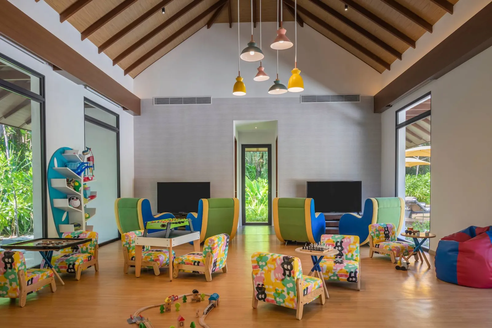 The Kids Playground room, with its coloured tables, toys and timber ceiling.
