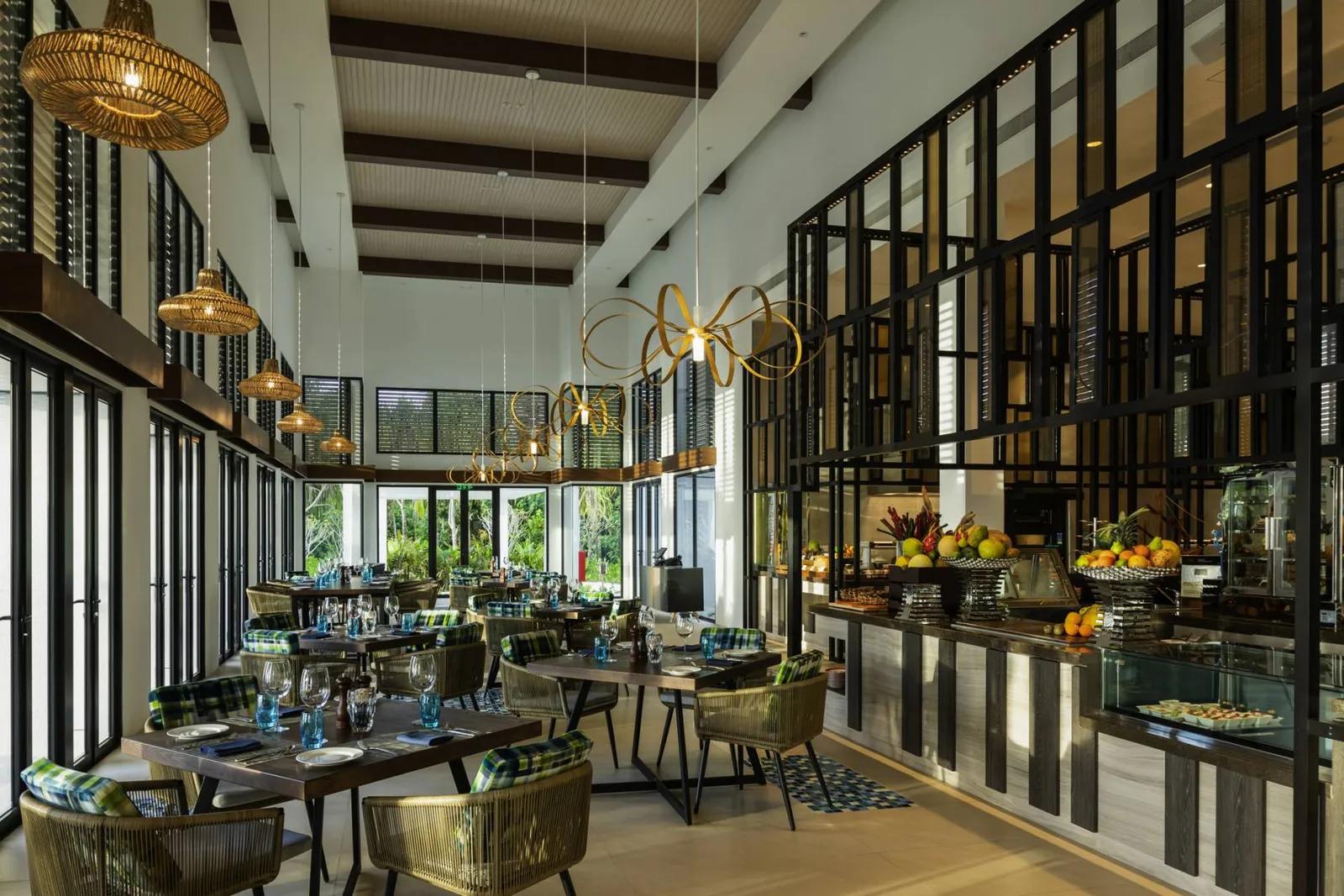 Mélange, the main restaurant, with its tall windows and tables between the columns.