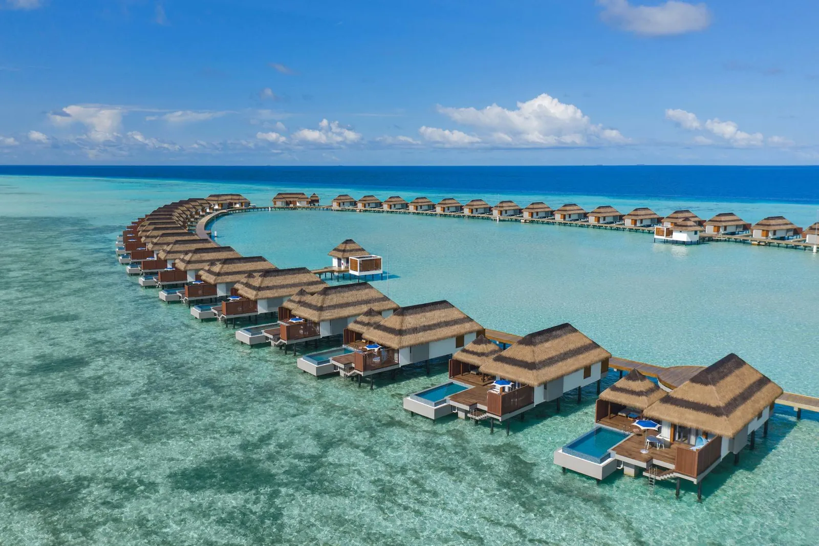 The row of Ocean Pool Villas on the lagoon, each with a pool on its deck.