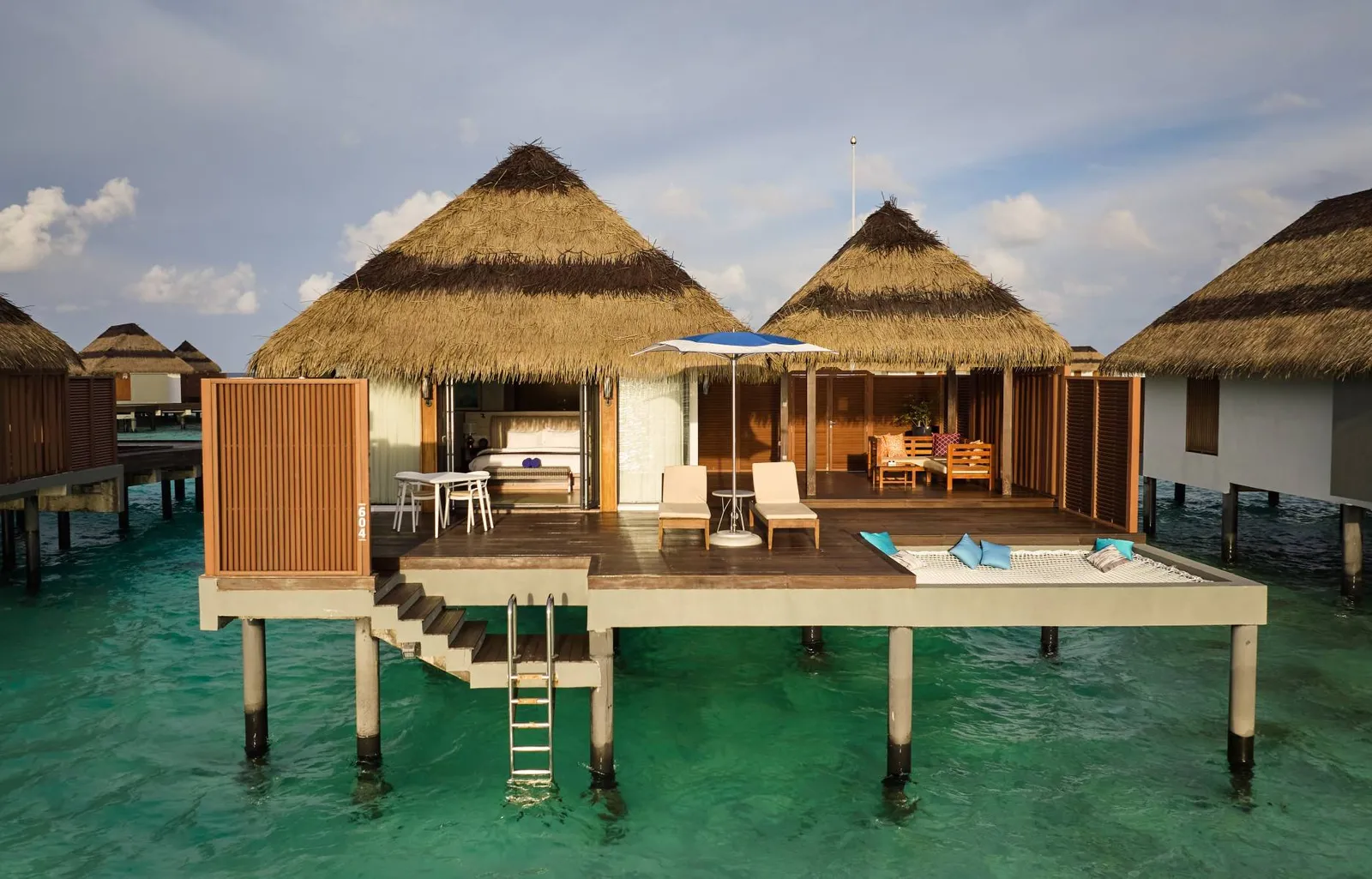 An Ocean Villa on the lagoon, its ladder dropping into the water from the deck.
