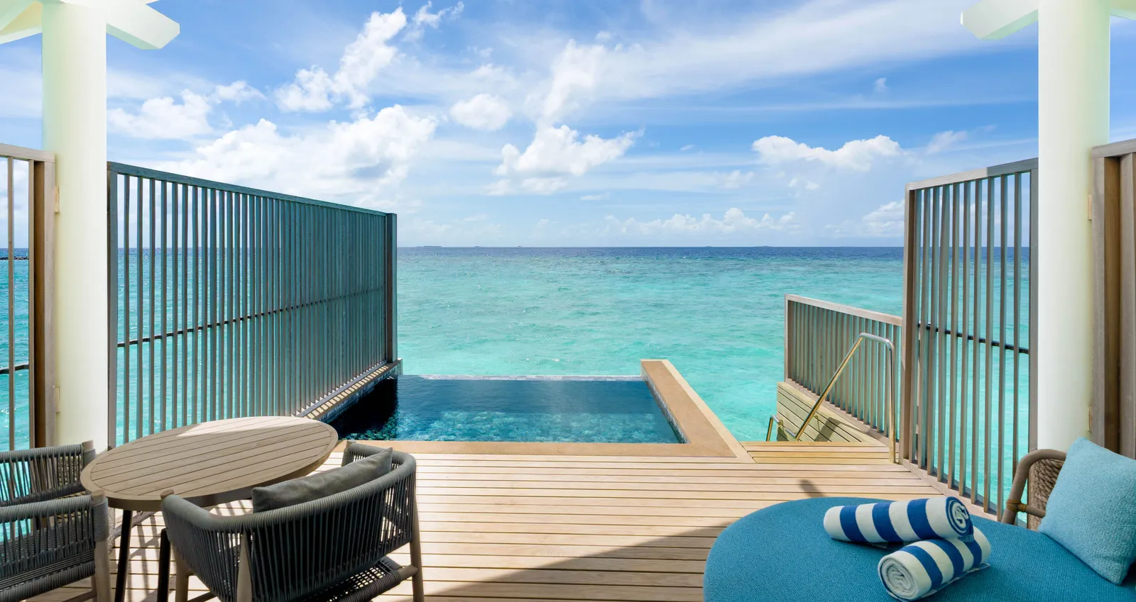 A Deluxe Water Villa with Pool’s plunge pool facing the open sea, between 2 timber screens.