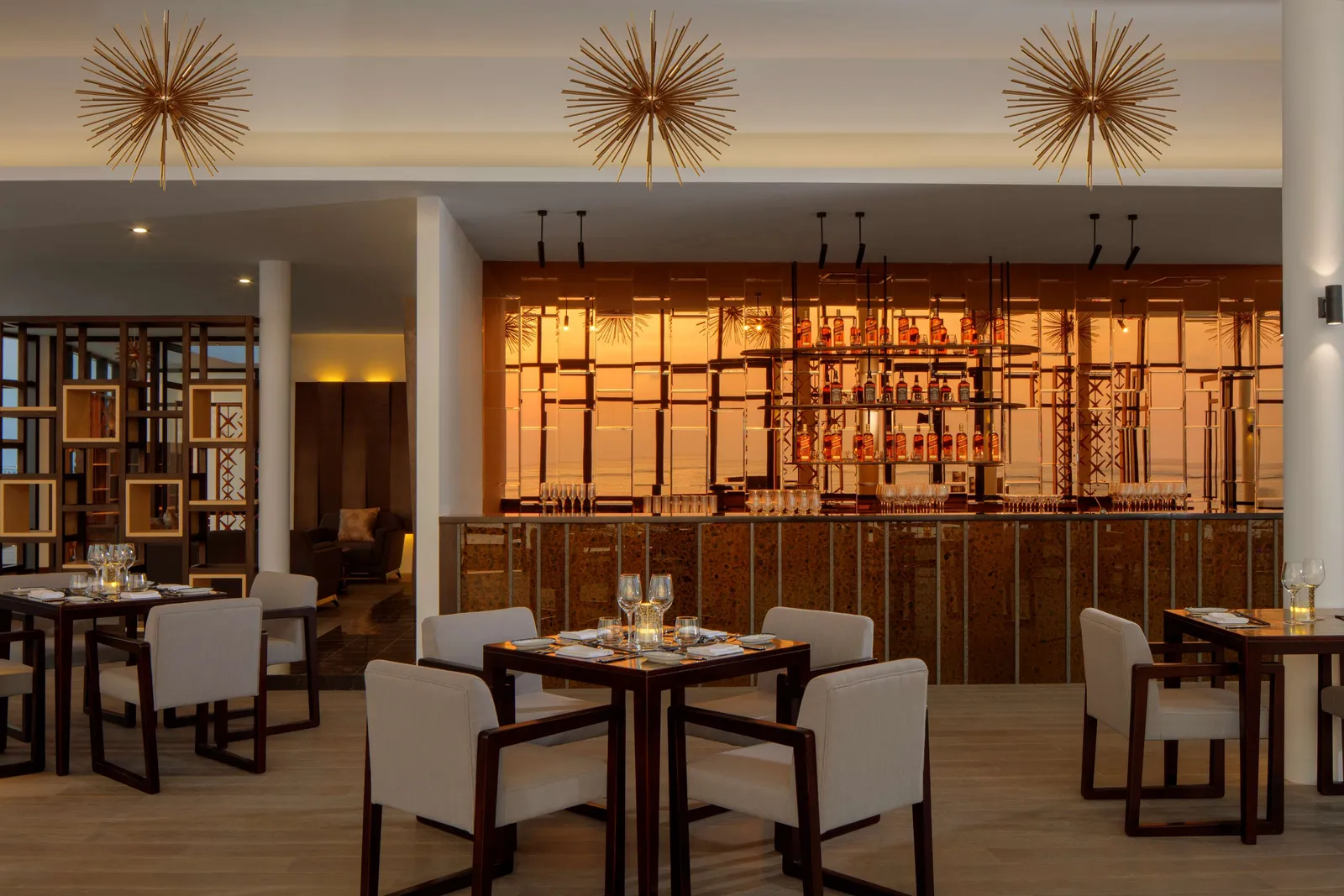 Kabuki’s dining room, with the lit counter, laid tables and starburst lamps.