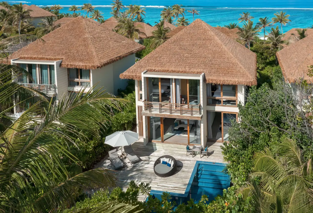 A 3-bedroom family villa from above, on 2 floors among the palms, with its pool on the deck.