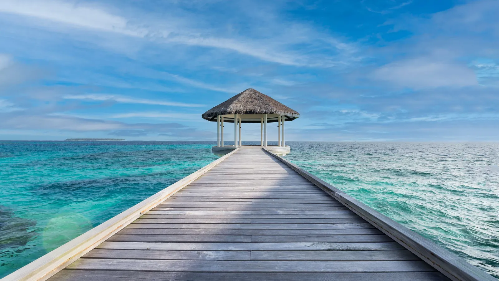 The timber jetty leading out to the yoga pavilion over the sea.