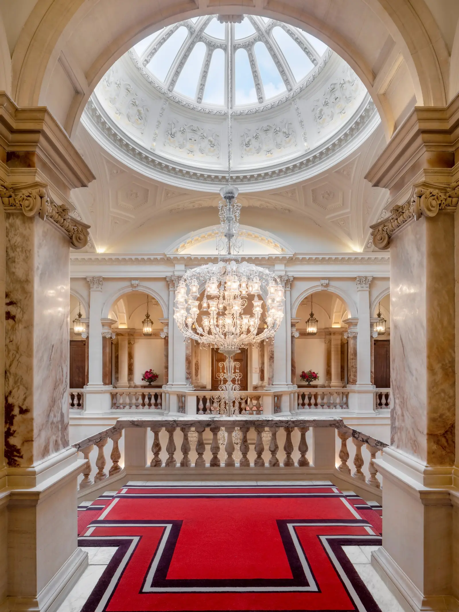 The Old War Office’s marble staircase, with its red carpet, columns and a glass dome above