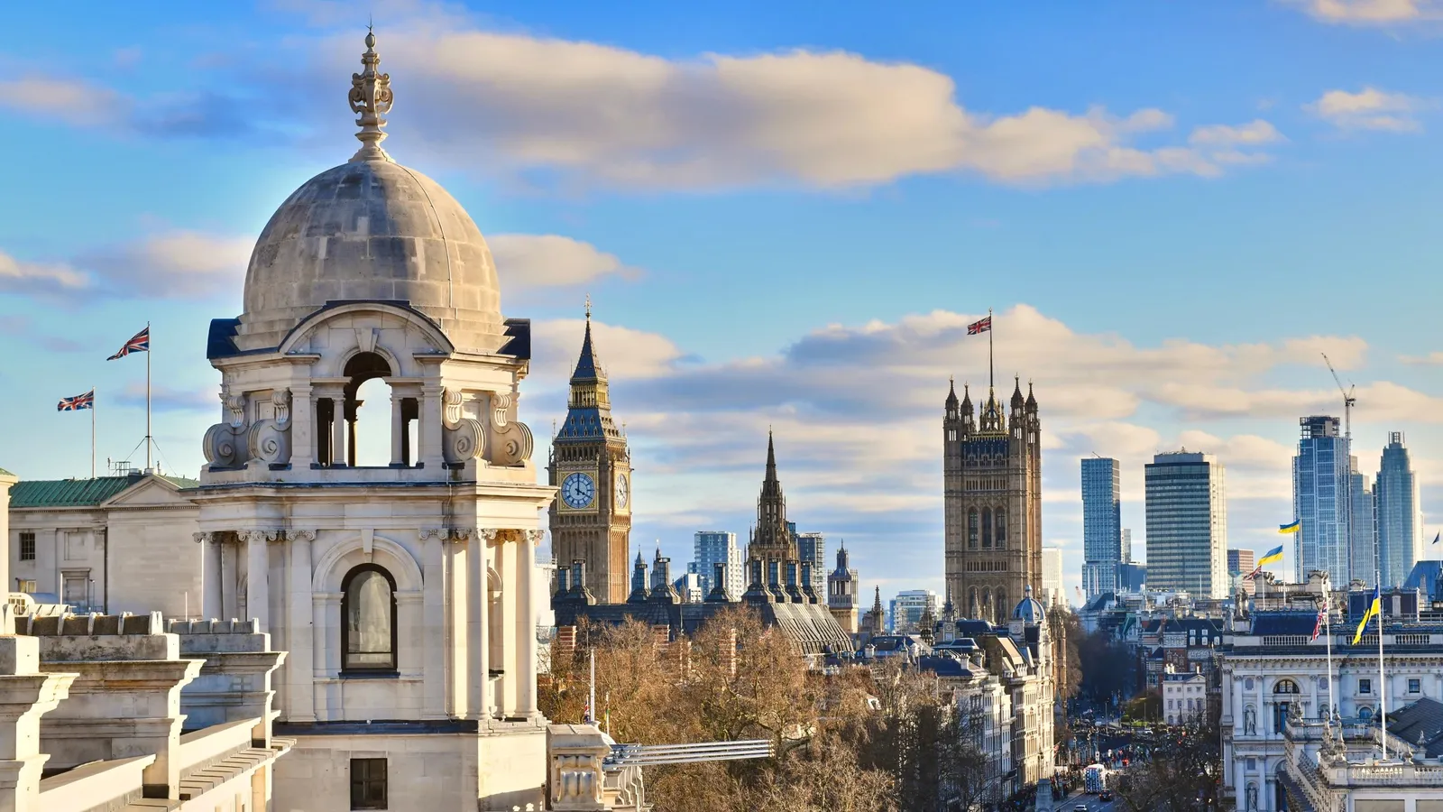 The view from The OWO’s roof: a dome, Big Ben and the roofs of Westminster under a blue sky