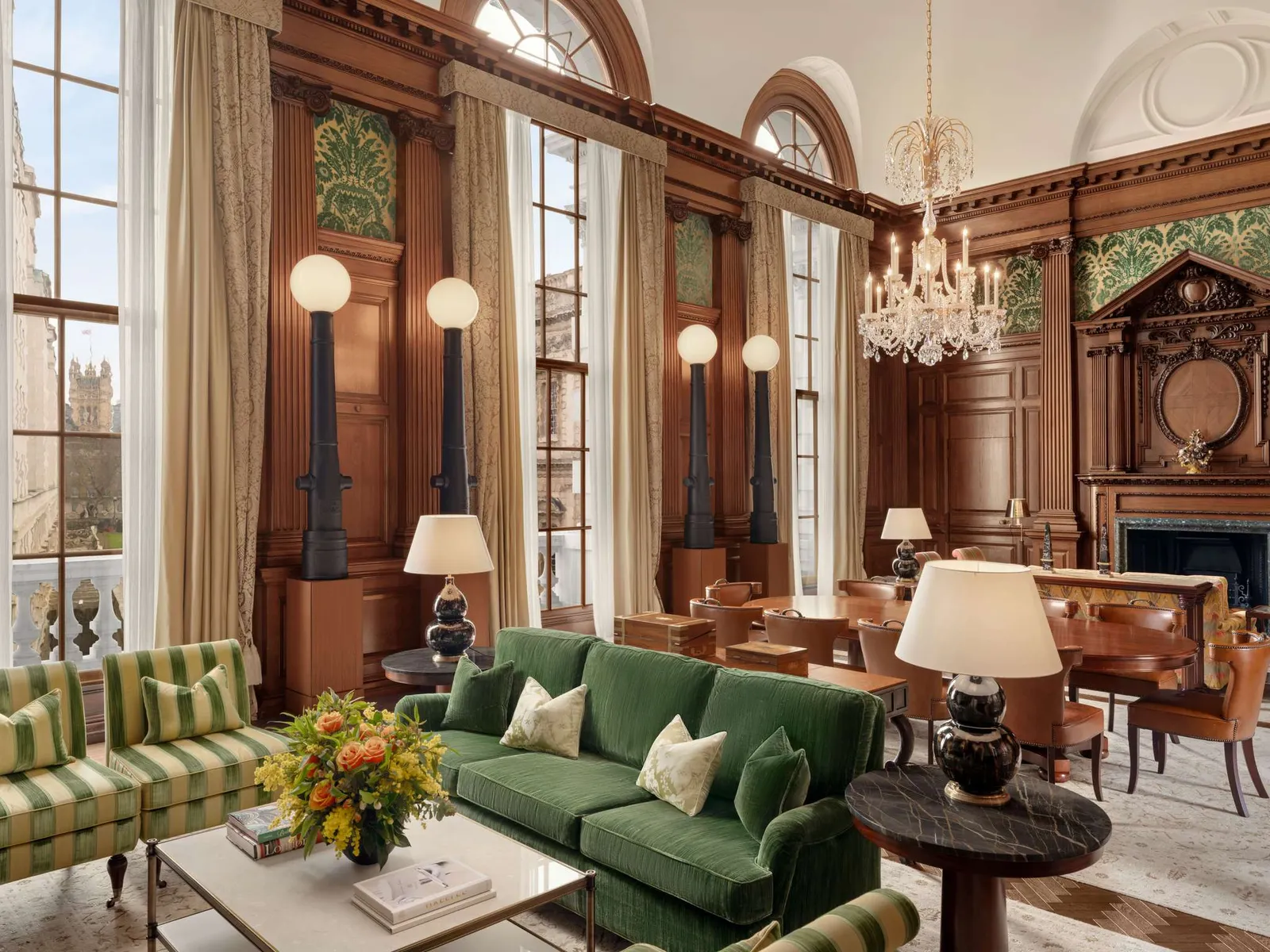 The Churchill Suite: wood-panelled walls, a chandelier, a green sofa and tall windows onto Horse Guards Avenue