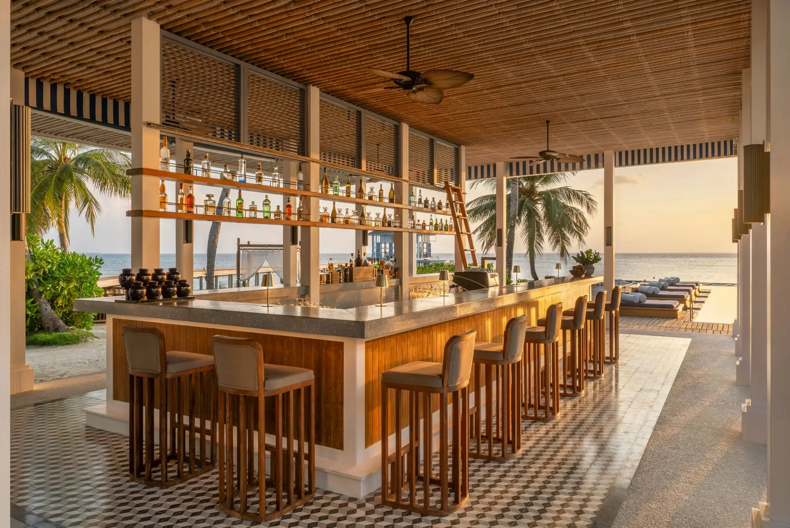 Bell Bar’s counter, bottles on the shelves and the beach beyond the columns