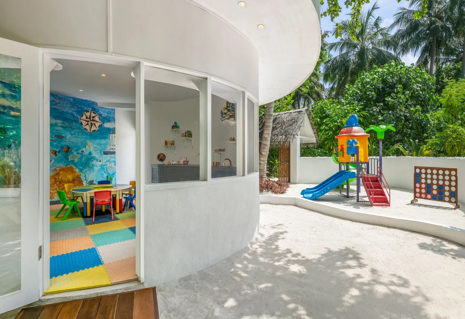 Faru Kids Club, its painted playroom and the slide in the garden