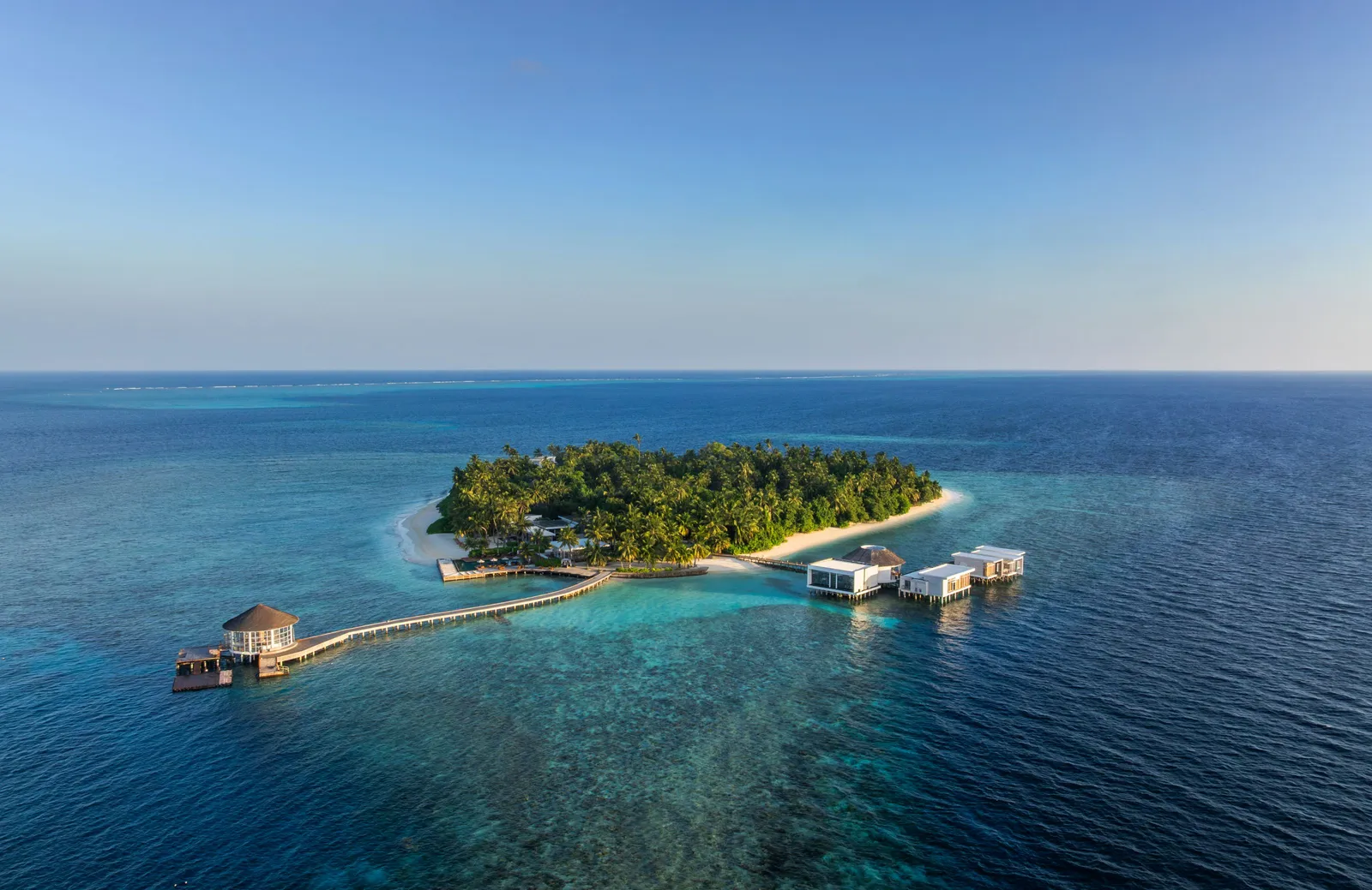 Meradhoo from the air, the green island with its arrival jetty and the ocean around it