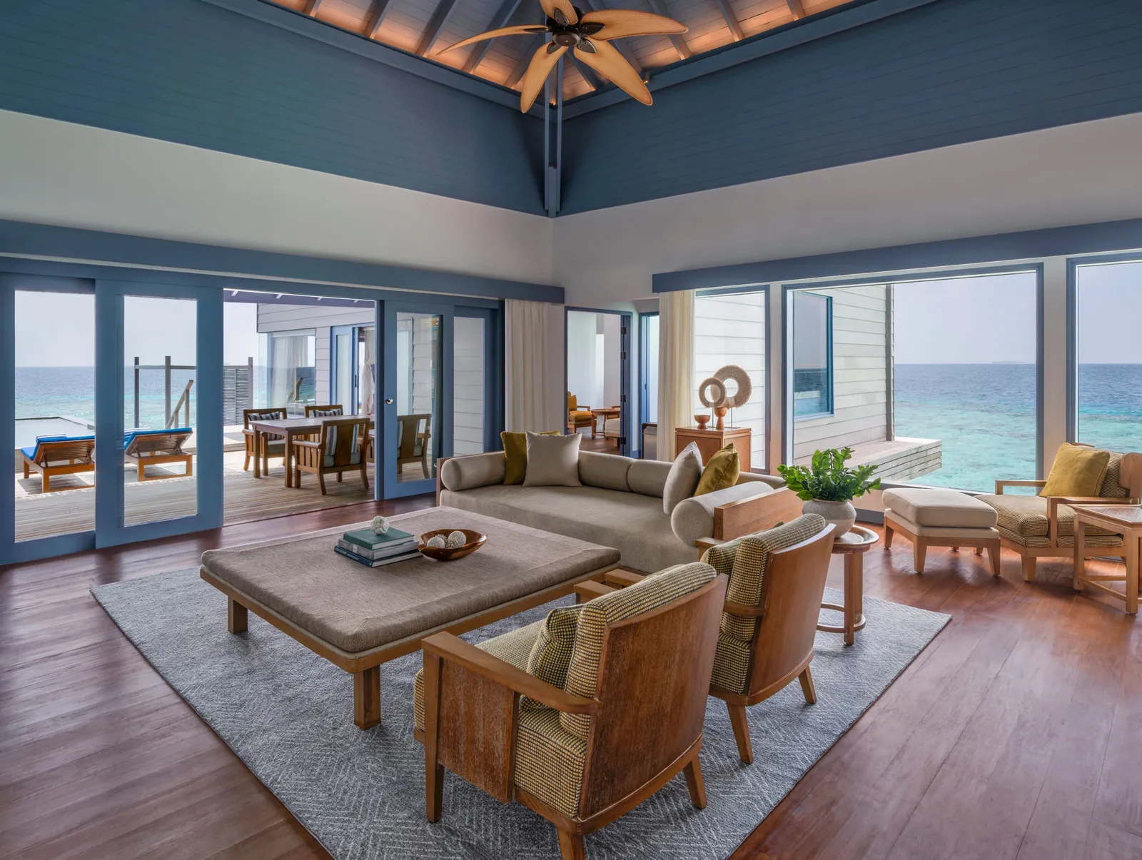 The living room of a 2-bedroom Overwater Retreat, its windows onto the ocean