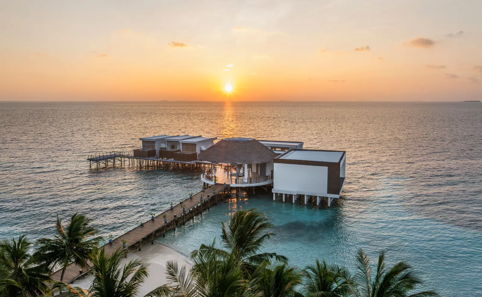 Halcyon Spa over the water at sunset, its pavilions at the end of the jetty