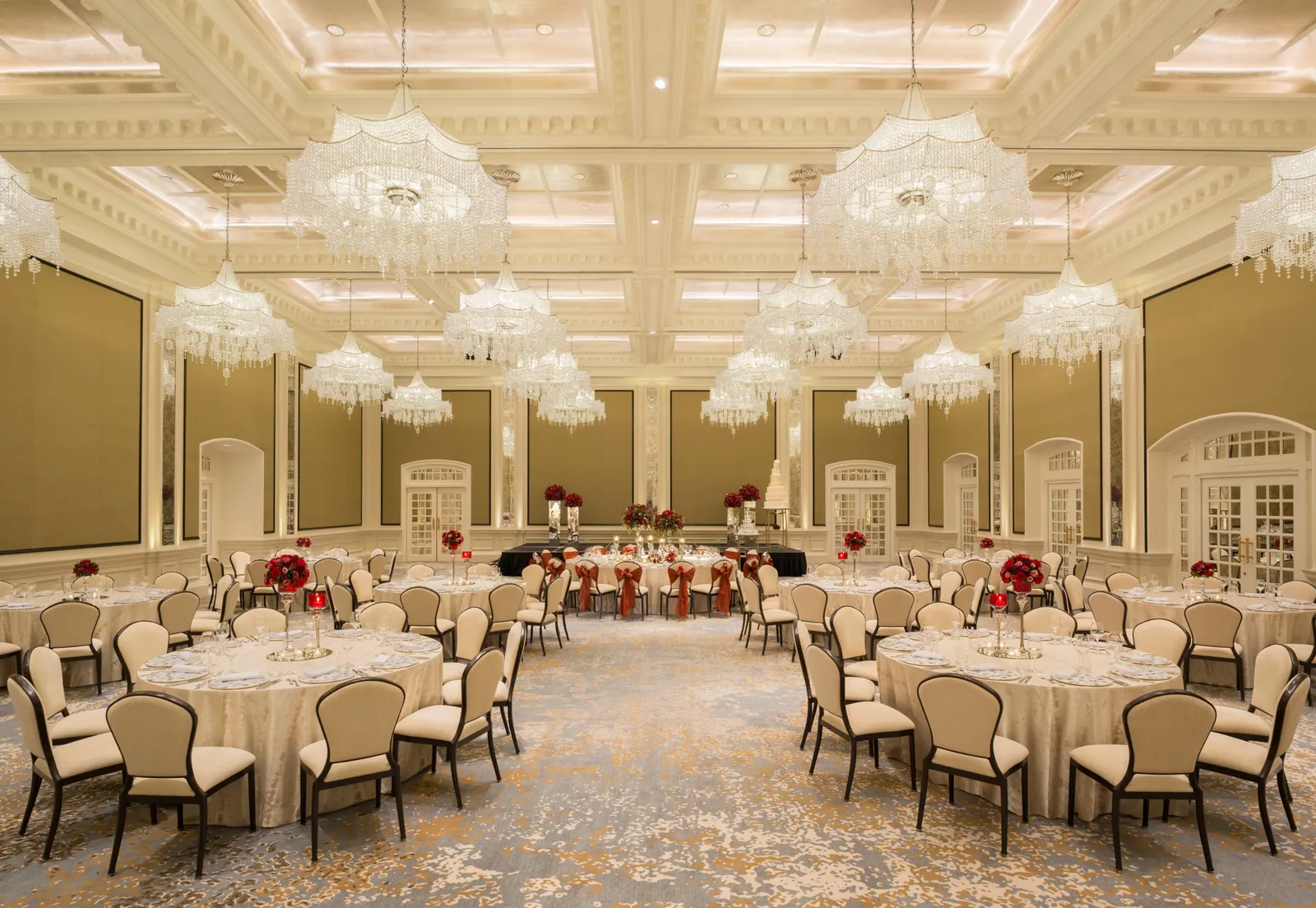 The Jubilee Ballroom laid with round tables, under rows of crystal chandeliers.
