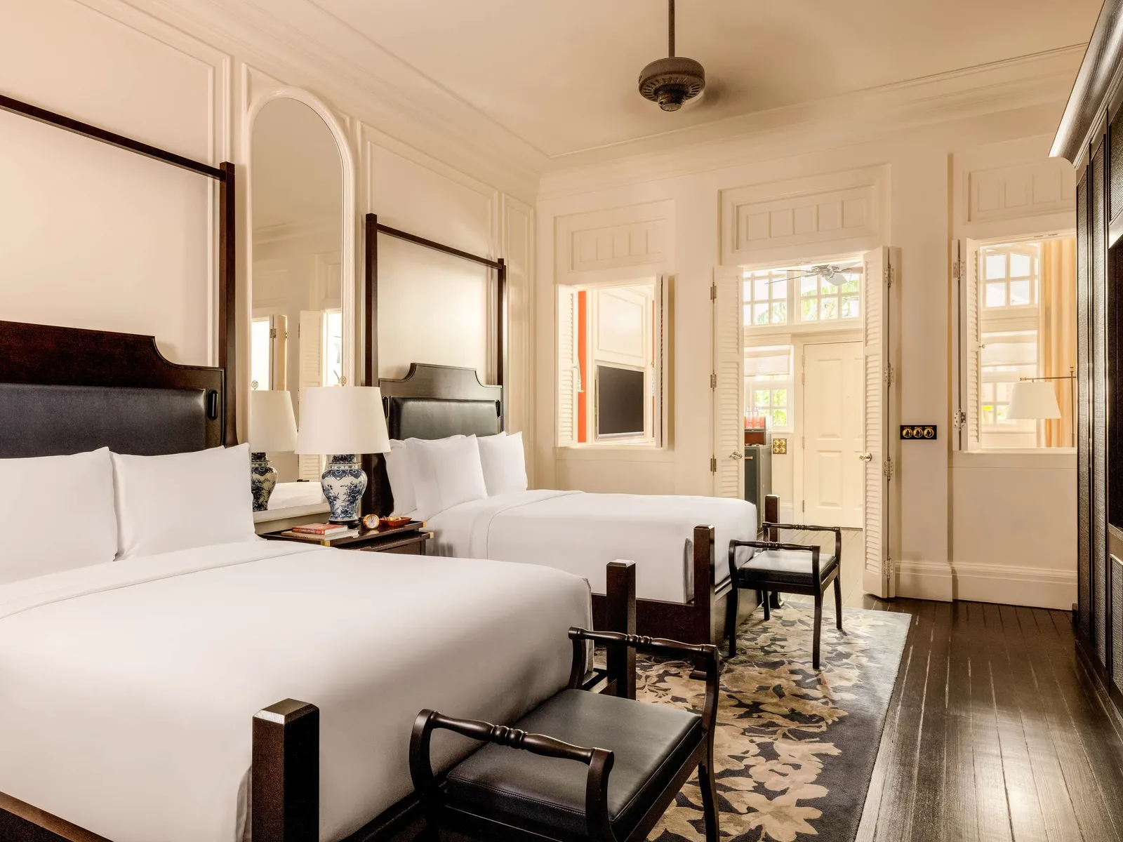 A Courtyard Suite bedroom with 2 double beds side by side and the ceiling fan.