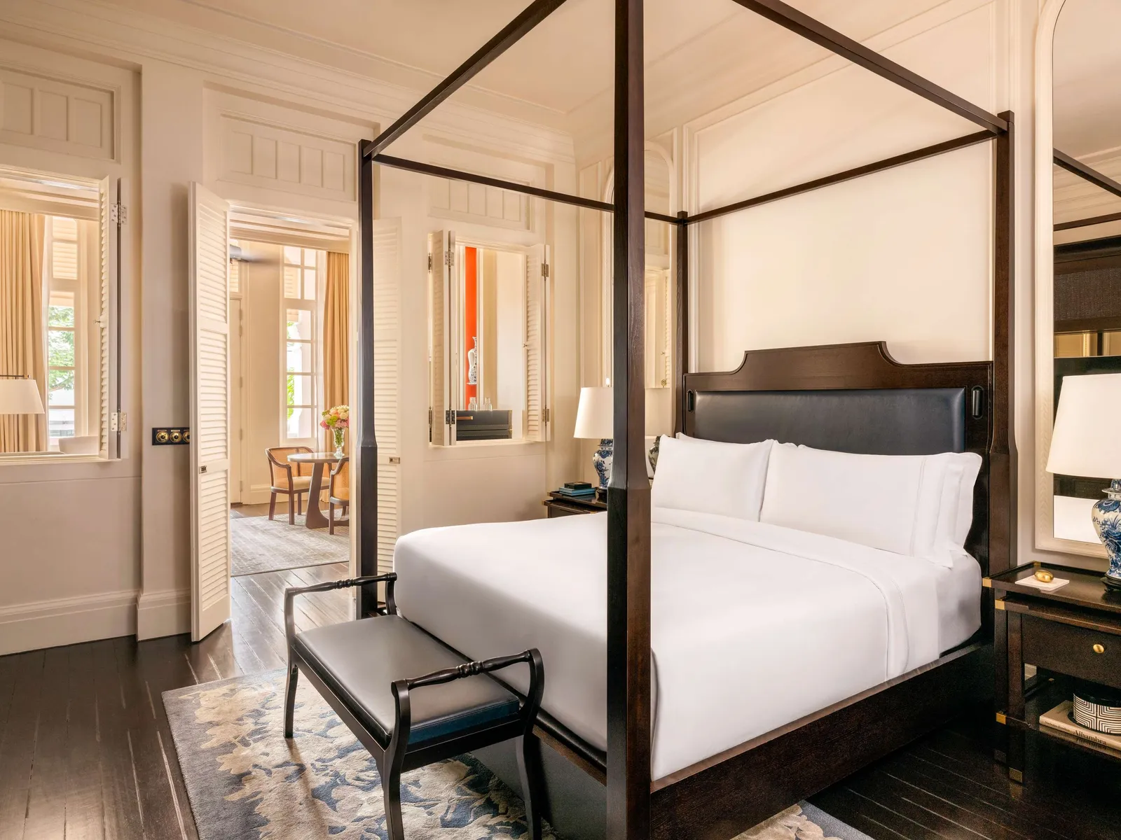 A State Room Suite bedroom: the four-poster bed and the door open onto the parlour.
