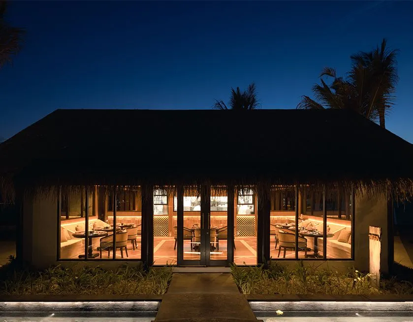 Tiffin at night, the dark pavilion with its lit windows and the path to the door.