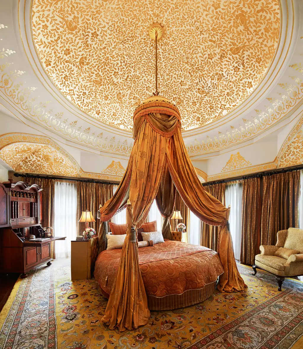 A Grand Presidential Suite with a round bed under a canopy and a decorated dome