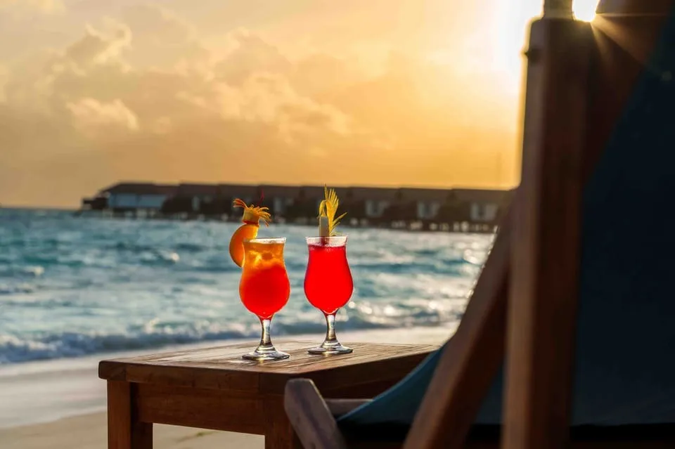 Tables and cocktails by the sea at sunset