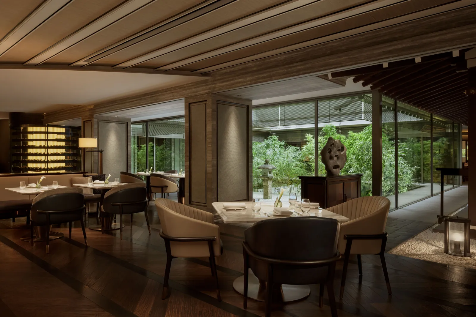 La Locanda’s dining room, its laid tables and the windows onto a bamboo garden with a stone lantern.
