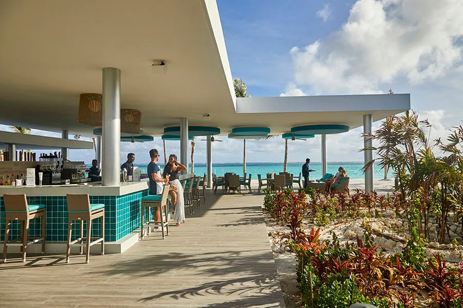 The Boduberu bar on its terrace, with a green-tiled counter and the sea beyond the rail.