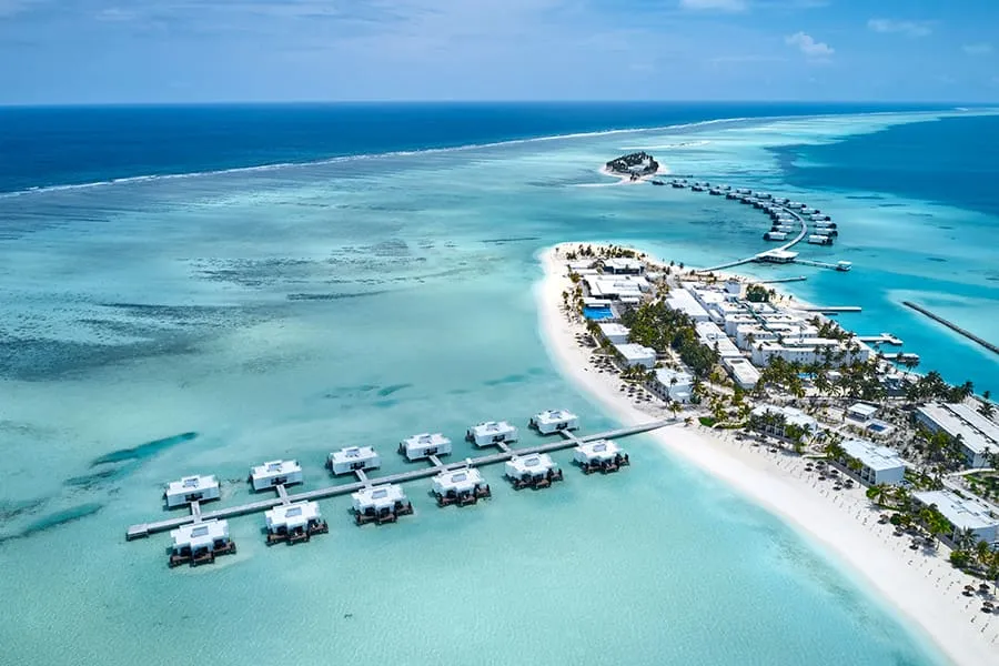 The overwater suites in a row along their jetty, and the walkway towards Kedhigandu, seen from above.