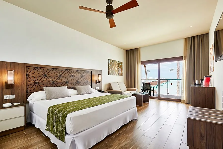The Double Standard: the king bed, the sofa, the ceiling fan and the French window to the balcony.