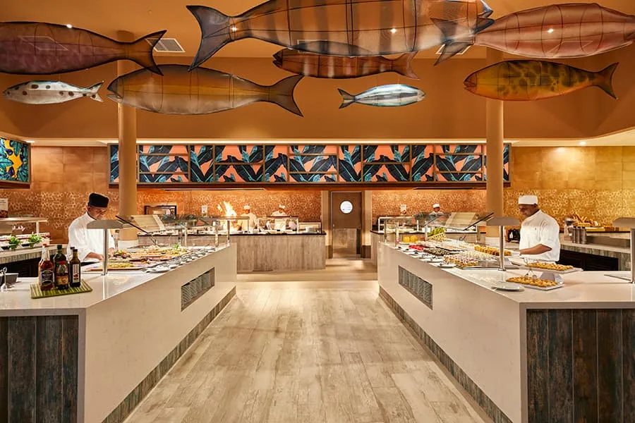 Palm’s buffet, with wooden fish hung from the ceiling, the food counters and 2 chefs at work.