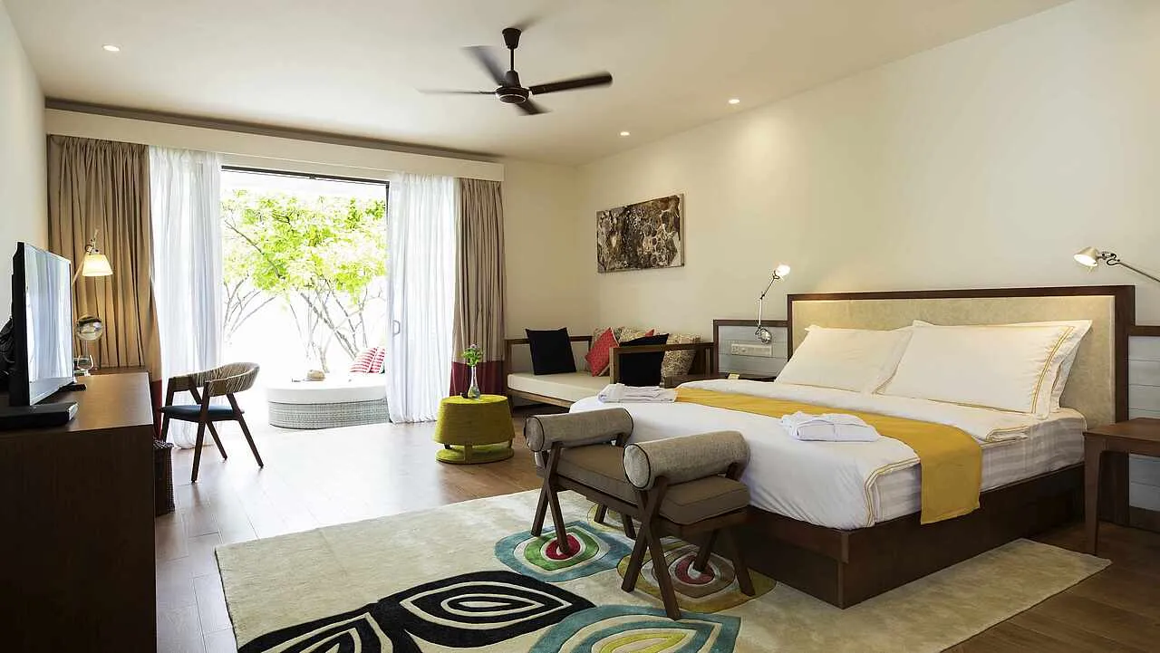 One of the 2 rooms of a Family Double Room: the double bed, the bright rug and the French window open onto the terrace.