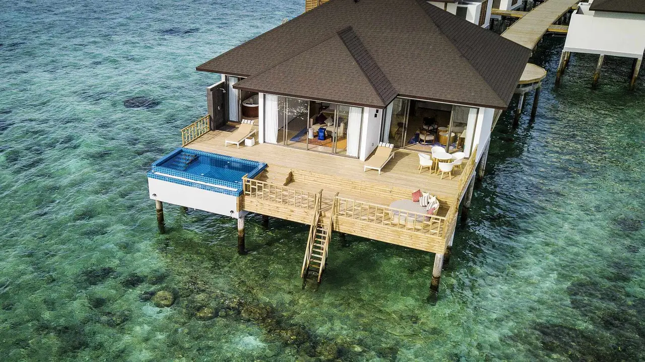 The One Bed Room Water Villa Pool from above, at the end of the jetty, with its private pool, deck and steps into the lagoon.