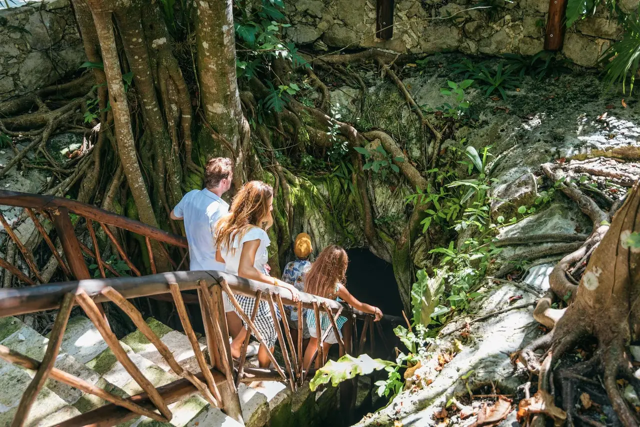 A couple on the walkway above a cenote in the jungle